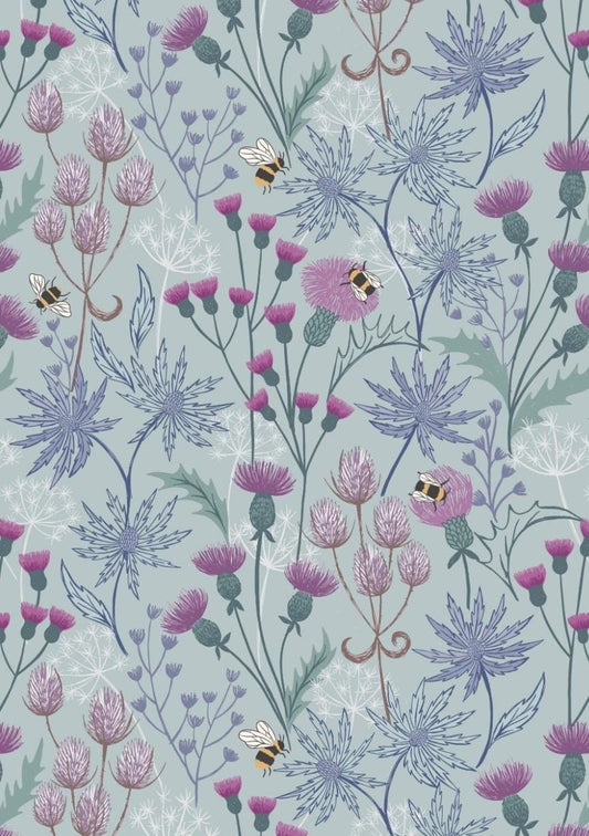 Celtic Floral fabric in Blue from A Celtic Summer collection by Lewis and Irene features buzzing bees in a floral meadow dotted with thistles against a sky blue background.