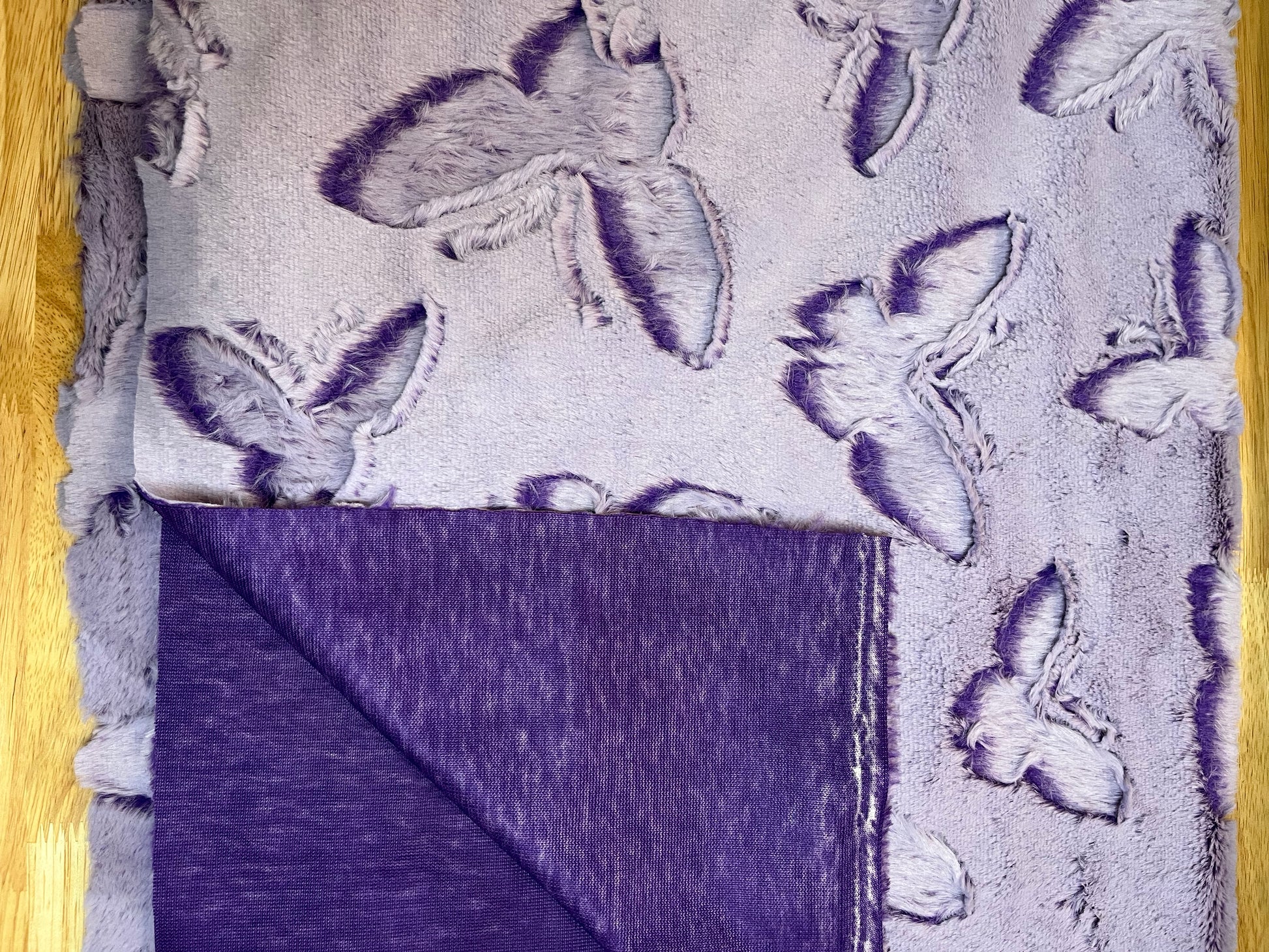 A photo of Frosted Butterfly Luxe Cuddle Cut from Shannon Fabrics showing the reverse side of the quilt backing.